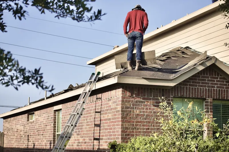 Professional roofer working on a residential roof in Logtown